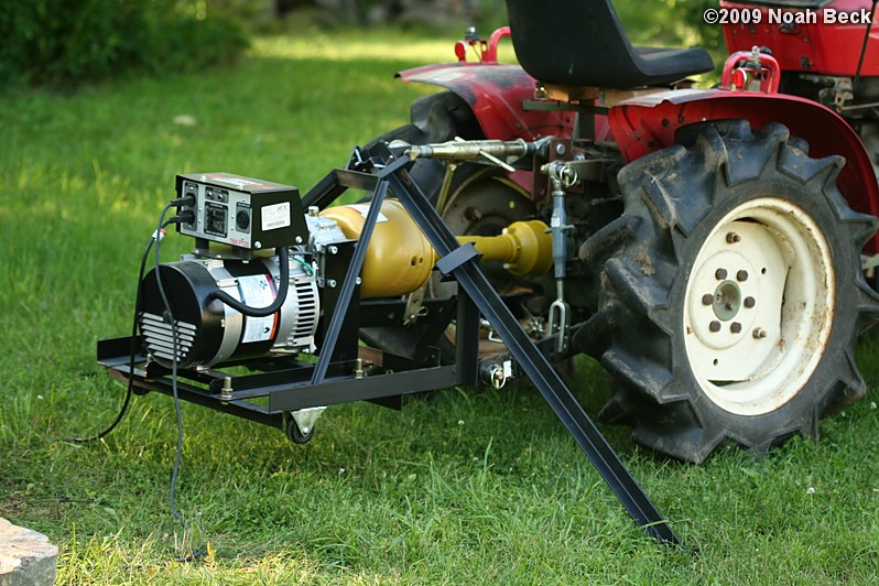 July 10, 2009: using the generator on the tractor to run the hammer drill and air compressor to split rocks