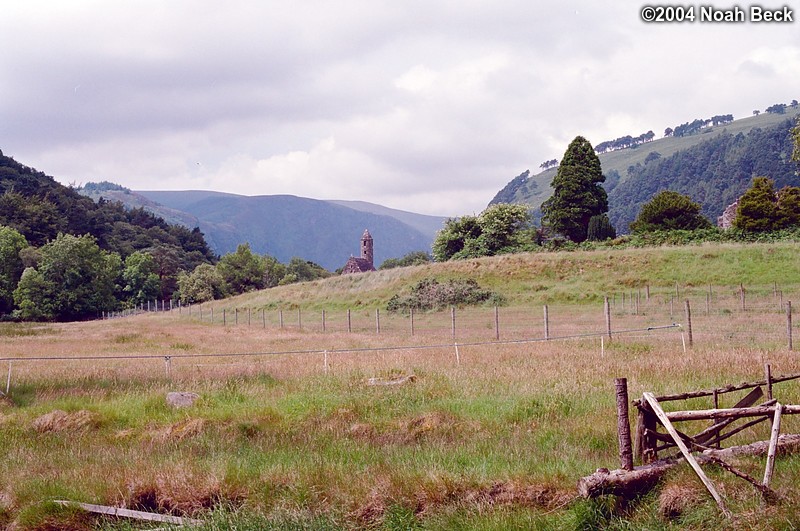 July 7, 2004: Glendalough is a monastic site that was founded in the sixth century. The round tower visible here is one of a few remaining ruins in this scenic valley.