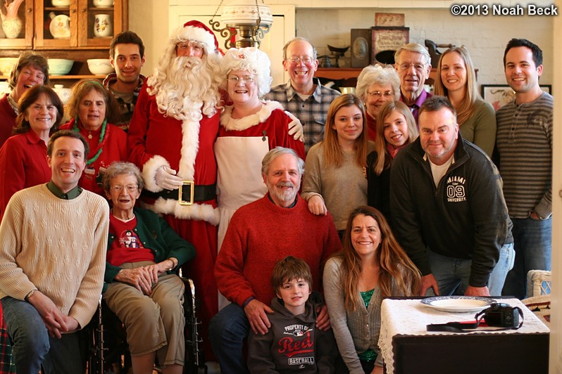 December 26, 2013: Group photo with Santa and Mrs. Claus.  Standing left to right: Raelynn, Terry, Nina, David, Santa, Mrs., Jim, Sophie, Becky, Tess, Bill, Adam, Anna, Mike; Sitting/kneeling left to right: Noah, Lucile, Michael, Llewelyn, Heather