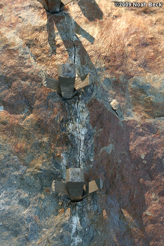 July 10, 2009: Using a hammer drill and feathers and wedges to split up rocks into rock steps