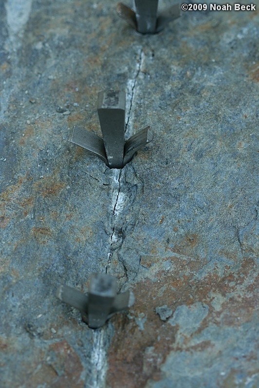 July 10, 2009: Using a hammer drill and feathers and wedges to split up rocks into rock steps