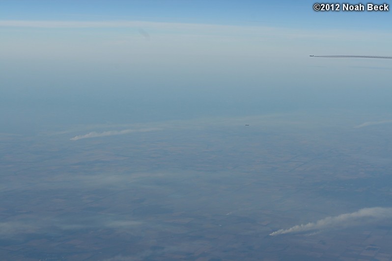 November 1, 2012: Two other planes seen out the window of my plane.  Smoke from sugar cane fields being burned can be seen on the ground.
