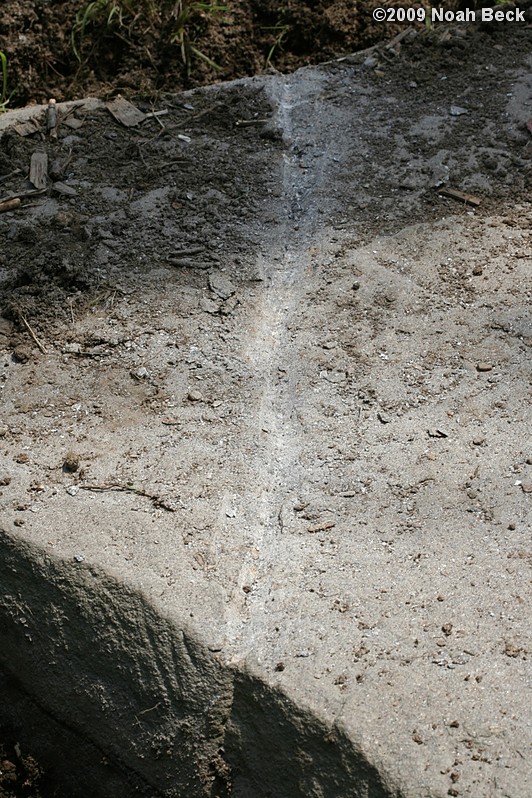 July 11, 2009: The rock was scored with a spud bar before drilling holes with a hammer drill and splitting it