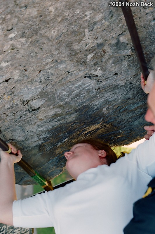July 5, 2004: Here is Roz pulling herself back up after kissing the Blarney Stone. The camera is pointed down and she is laying on her back. The light behind her is the ground outside the castle (about 100 feet down).