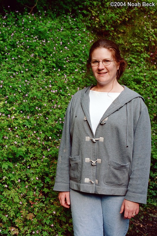 July 5, 2004: Roz standing next to rock covered with small flowers.
