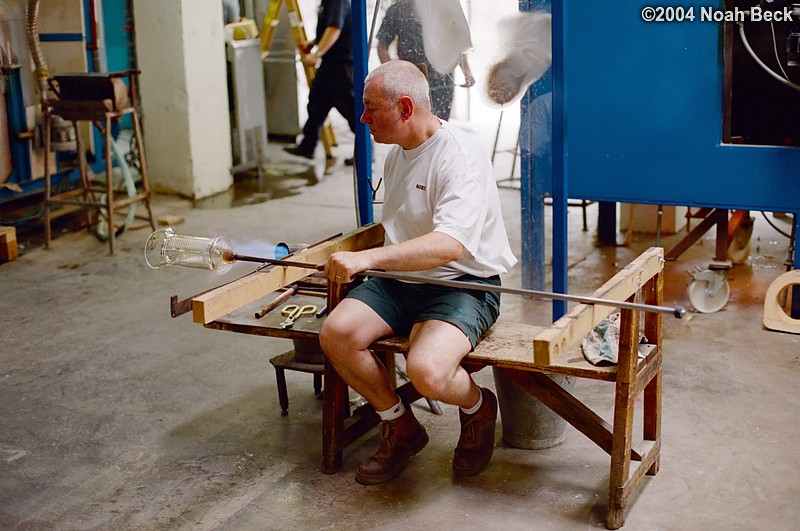 July 6, 2004: We toured the Waterford Crystal factory. This craftsman is heating a piece of crystal so that a handle can be affixed to its side.
