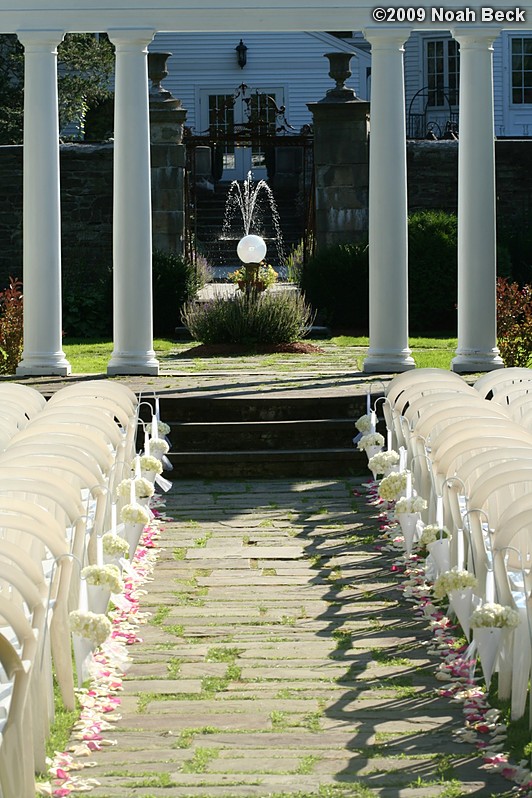 August 15, 2009: wedding ceremony aisle lined with floral cone accents